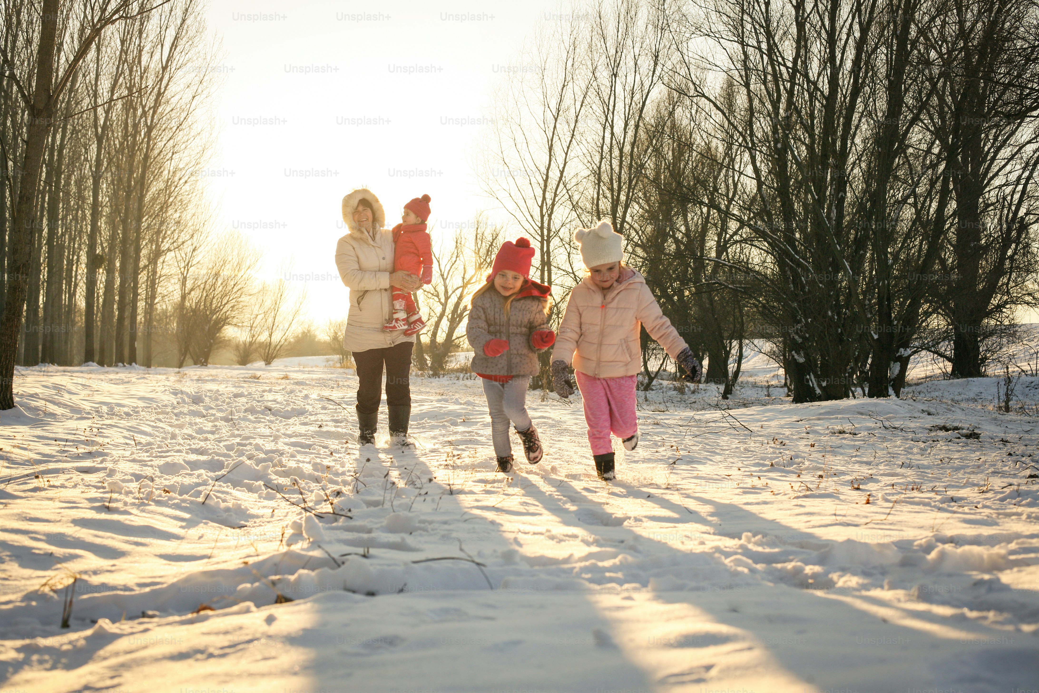 Happy grandmothers enjoying their grand children outside in winter - family portrait.