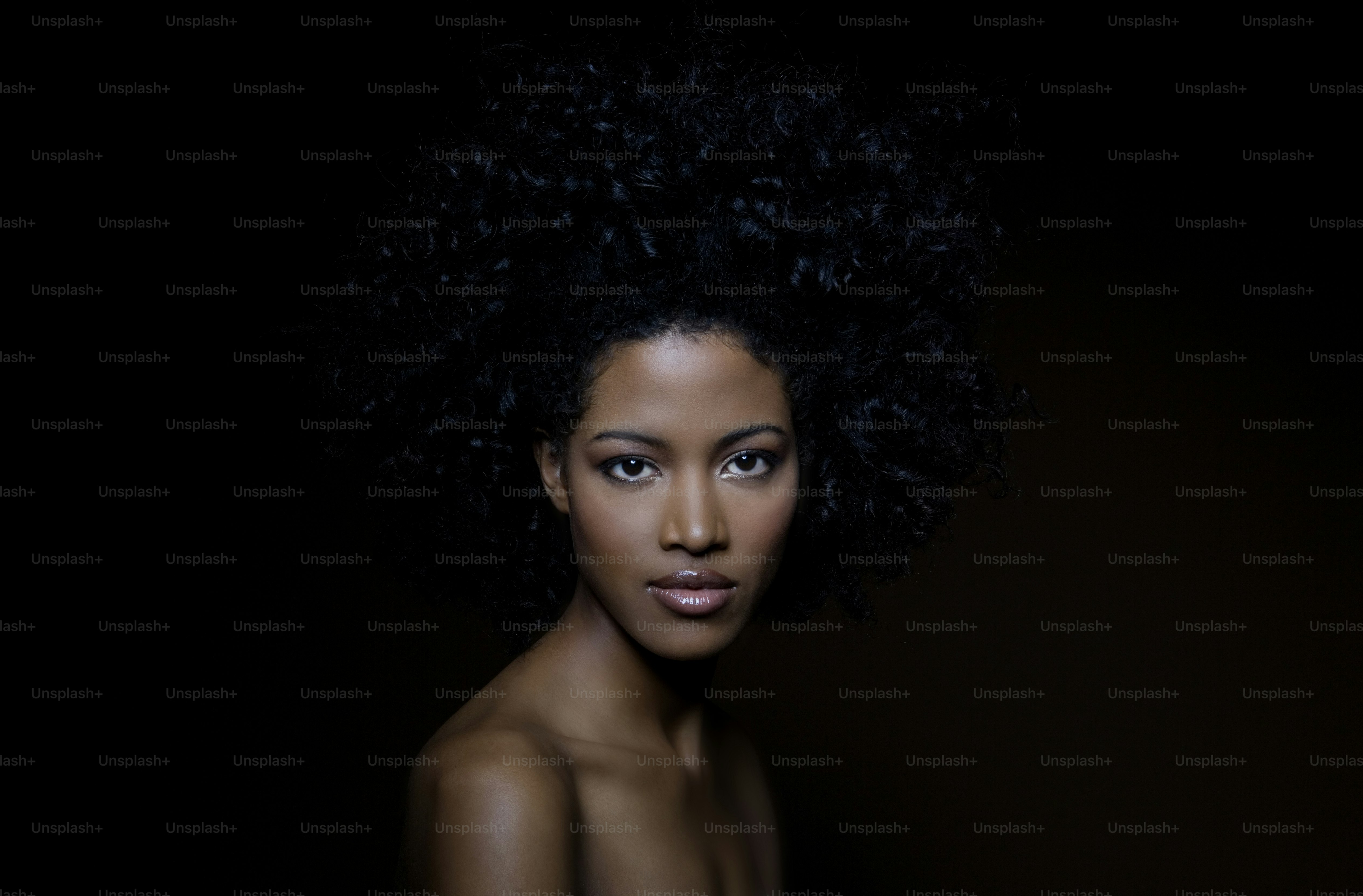 a woman with an afro is posing for a picture