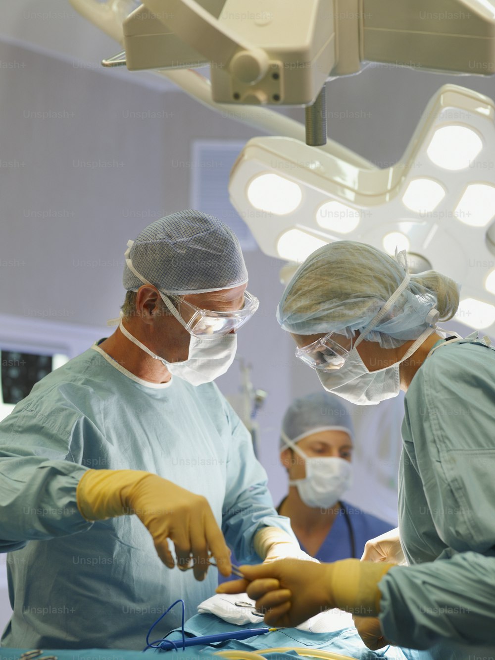 a group of doctors performing surgery on a patient