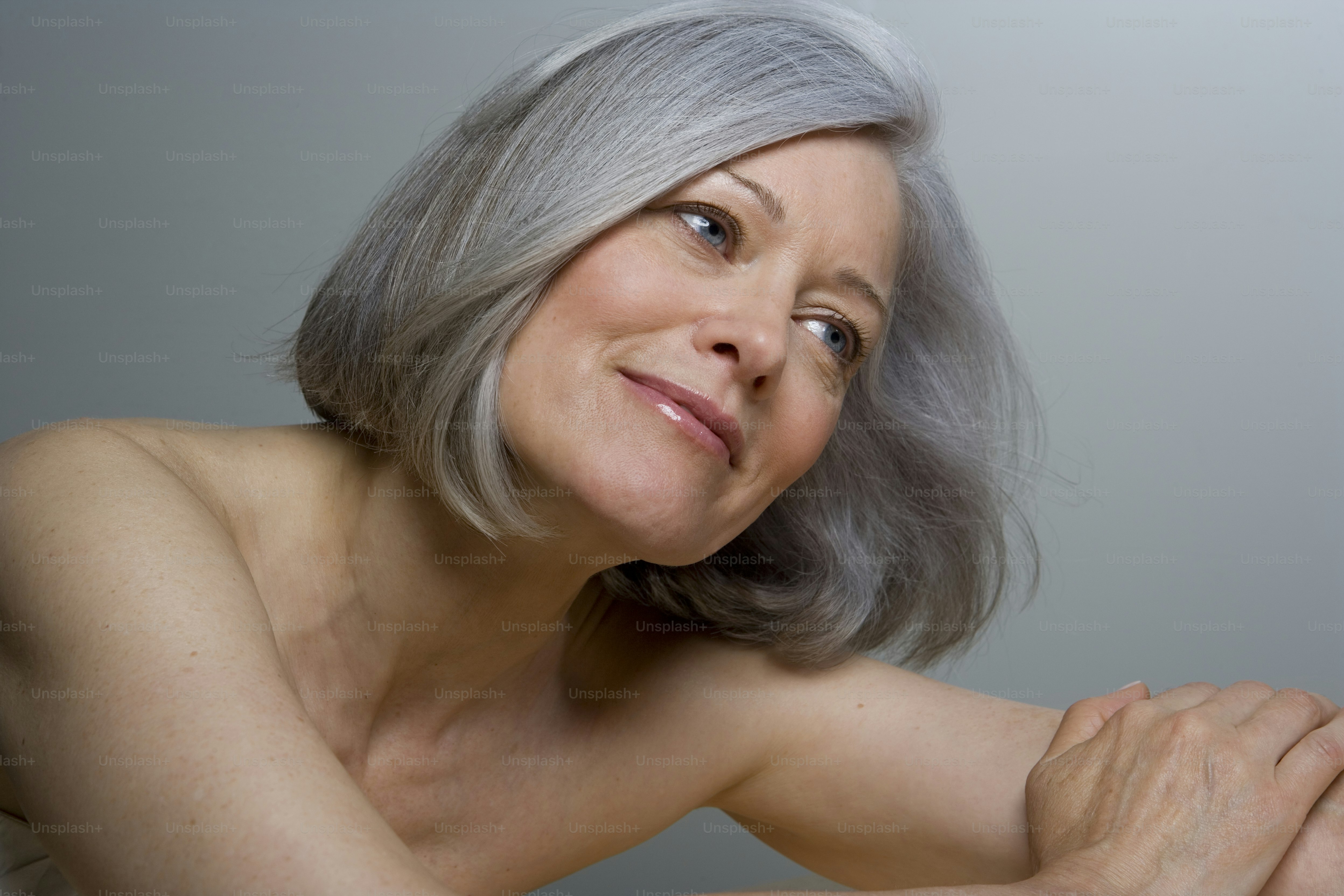 an older woman with gray hair posing for a picture