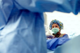 a woman wearing a surgical mask in a hospital