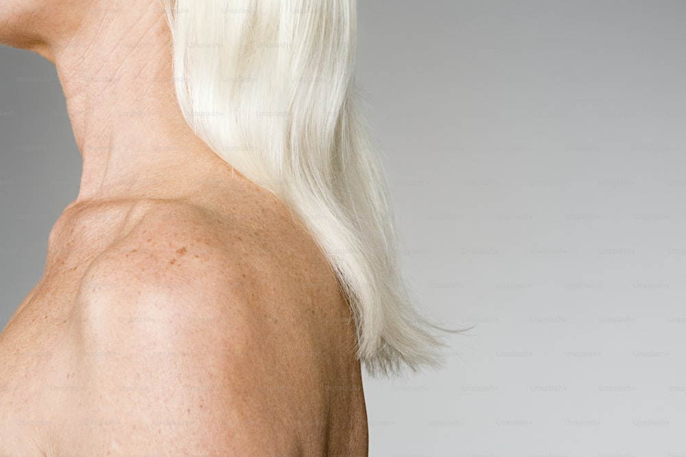 the back of a woman's head with white hair