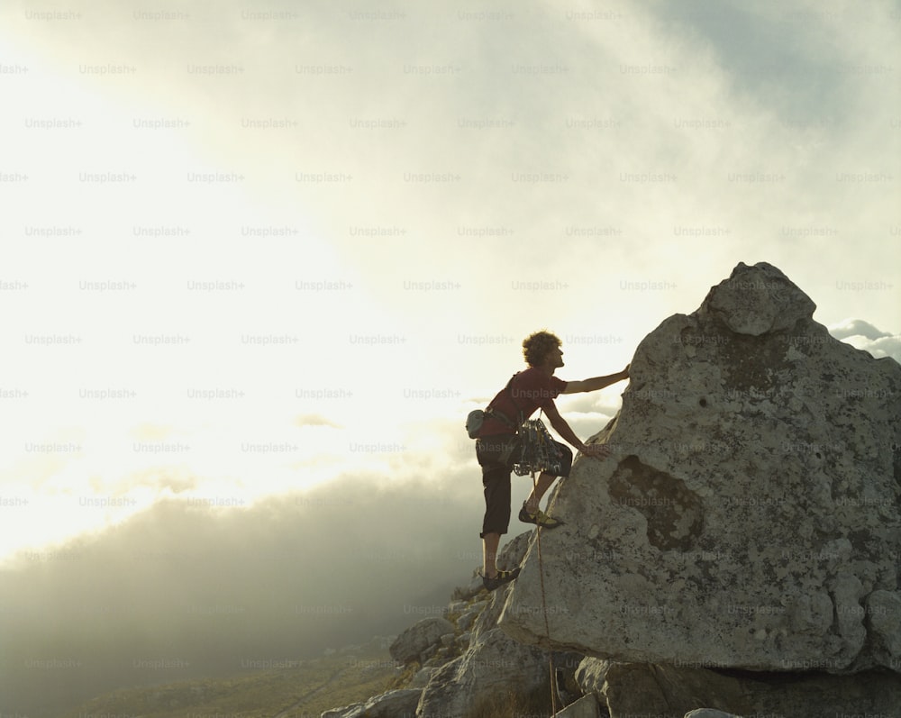 a person on a mountain climbing up a rock