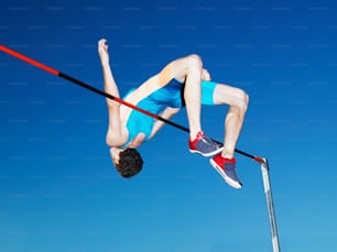 a man is high in the air on a pole