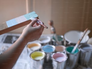 a person holding a paintbrush in their hand