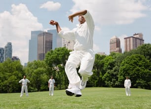 a man jumping in the air while playing a game of cricket