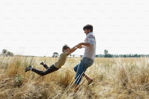 a man and a boy playing in a field
