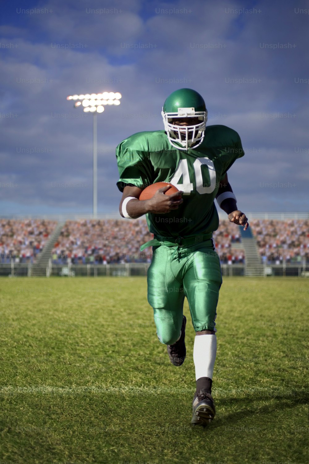 a football player running with the ball in his hand