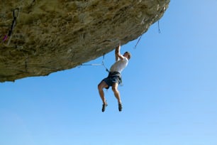 a man climbing up the side of a cliff