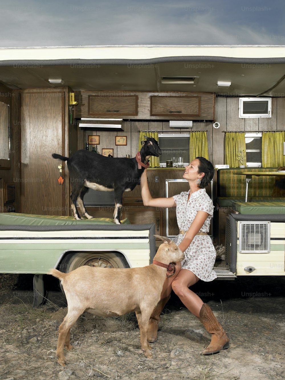 a woman standing next to a dog in a trailer