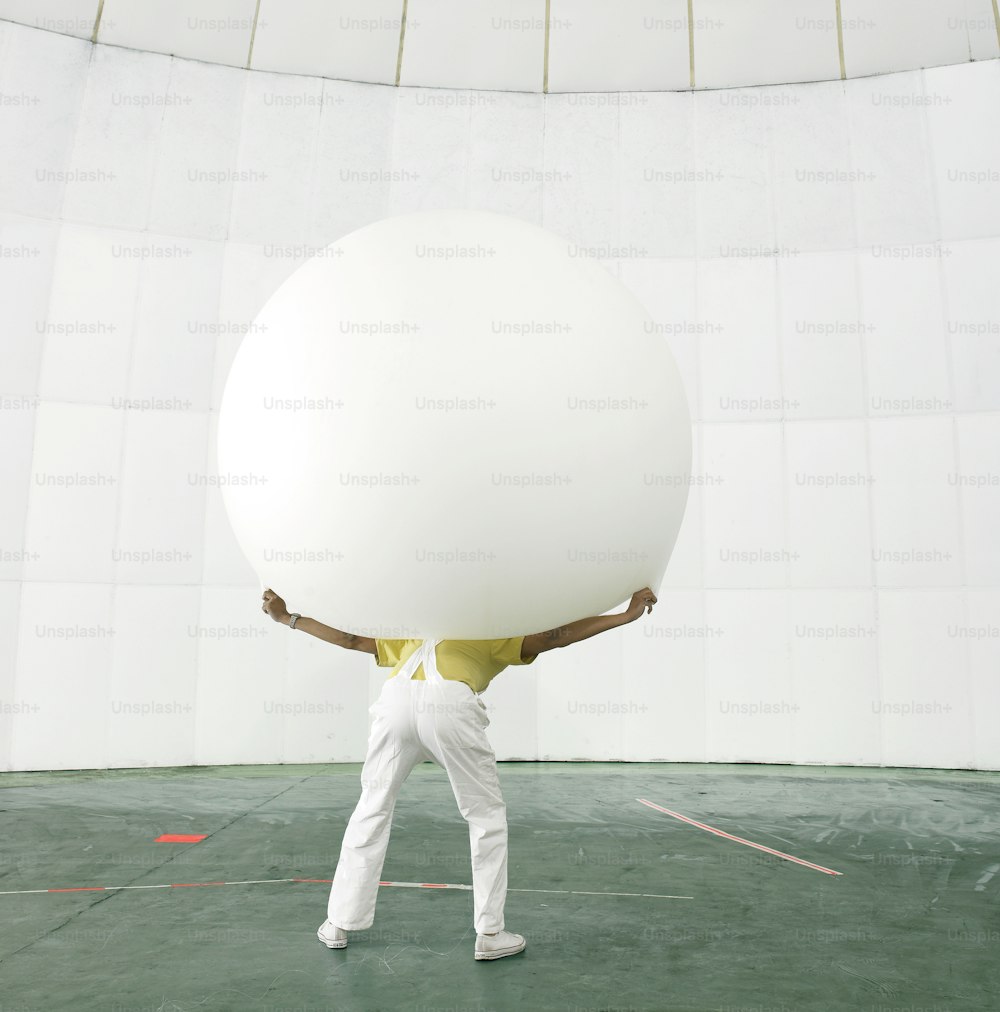 a man holding a large white object in his hands