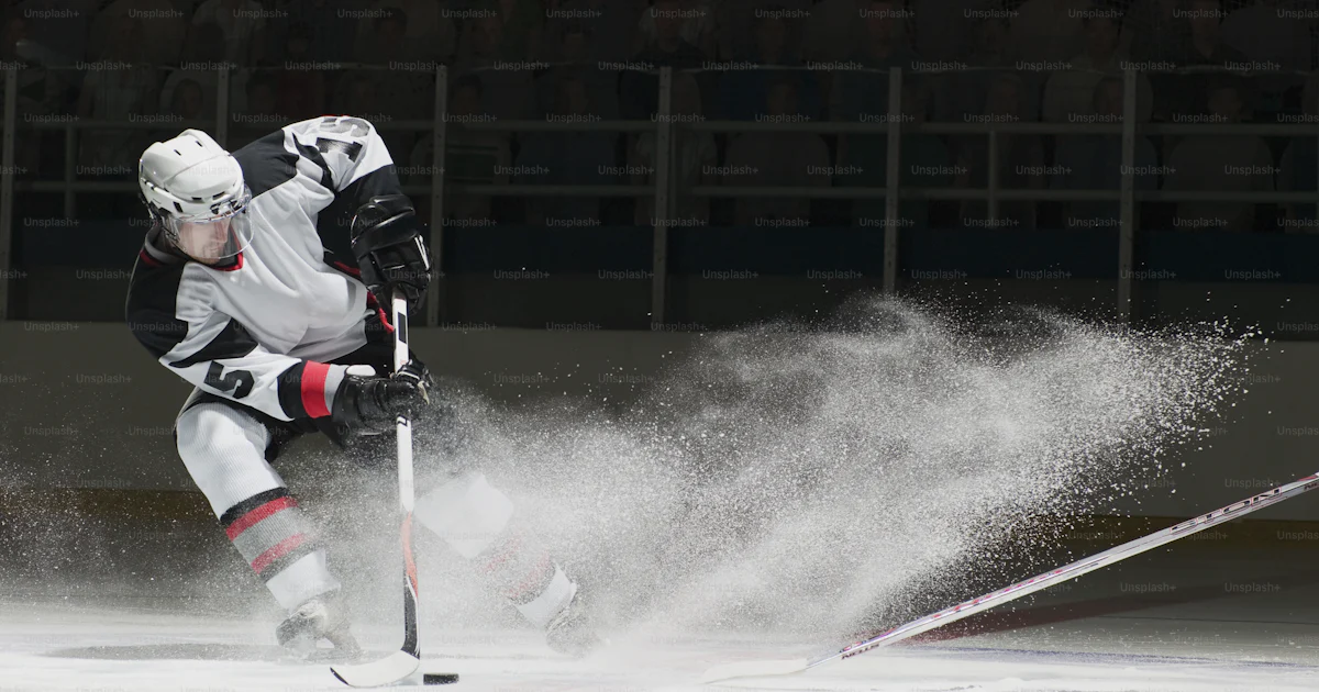 A person on a ice rink playing with a stick photo – Game Image on Unsplash