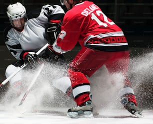 a couple of men playing a game of ice hockey