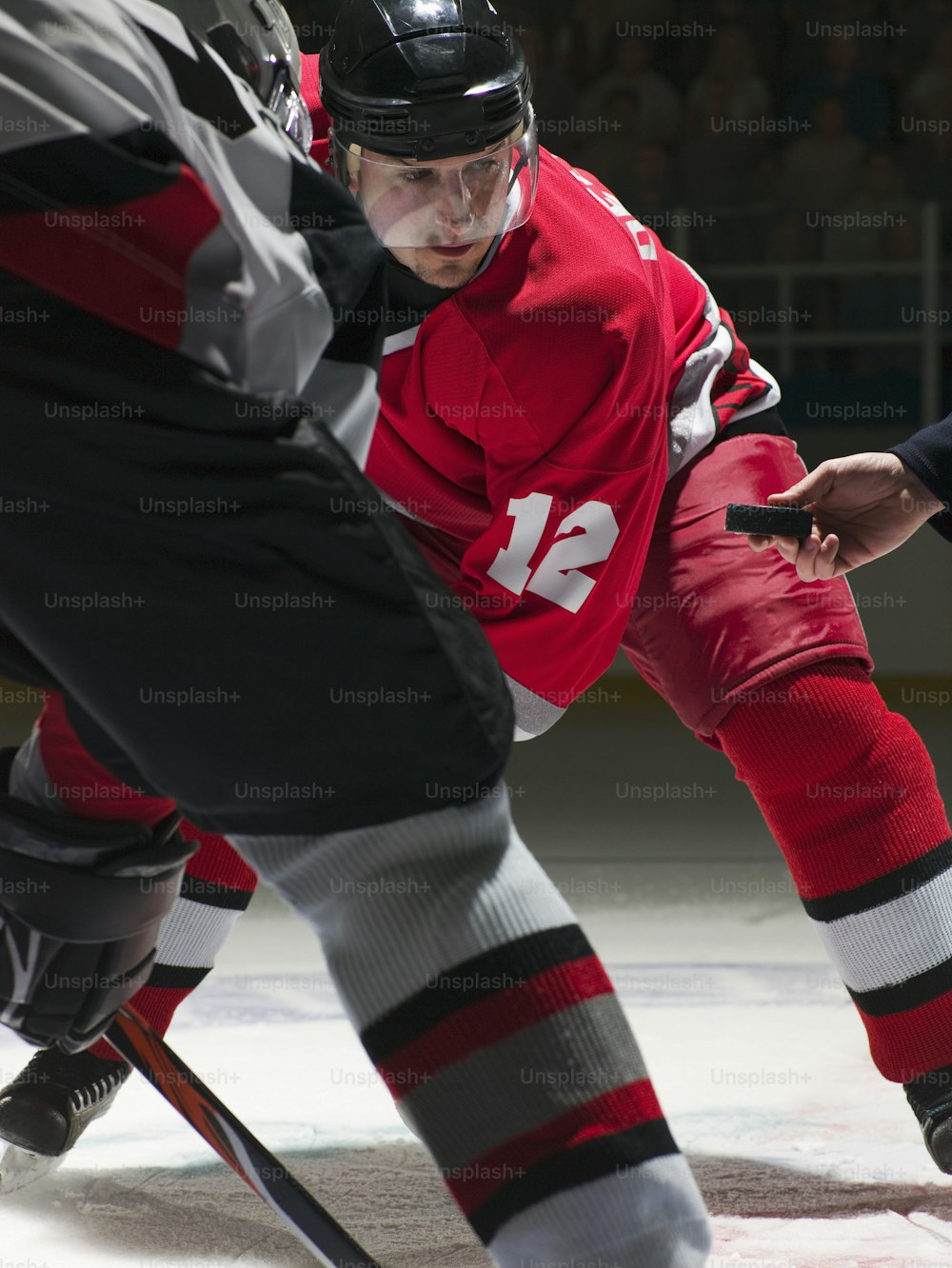 Un homme portant un maillot rouge joue au hockey sur glace