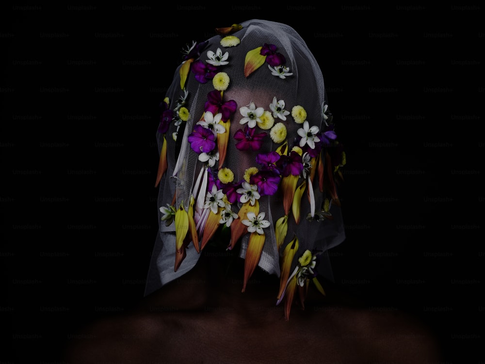 a woman wearing a veil with flowers on it