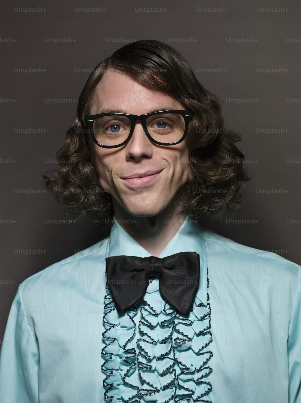 a man wearing a blue shirt and black bow tie