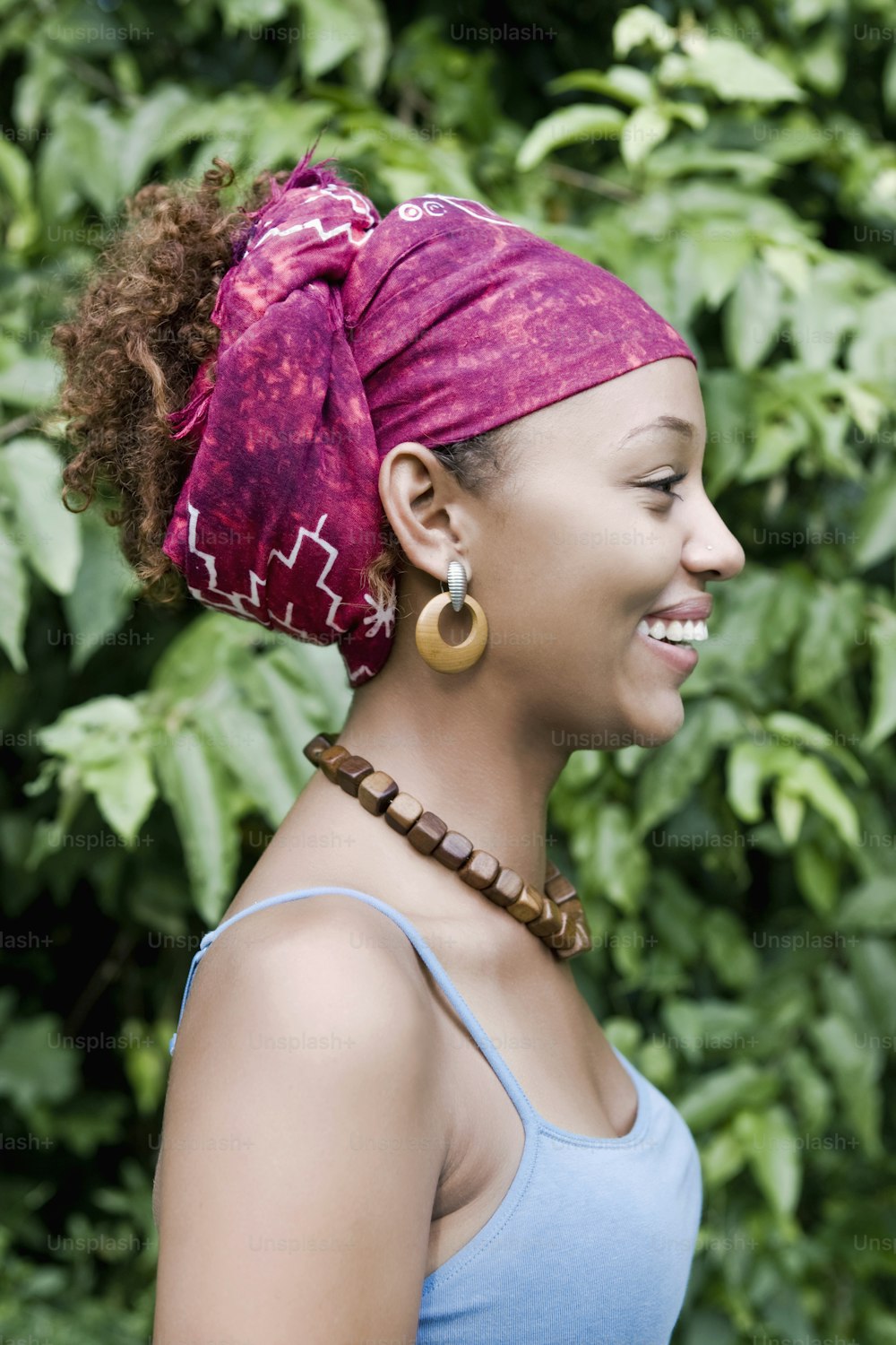 a woman with a pink bandana on her head