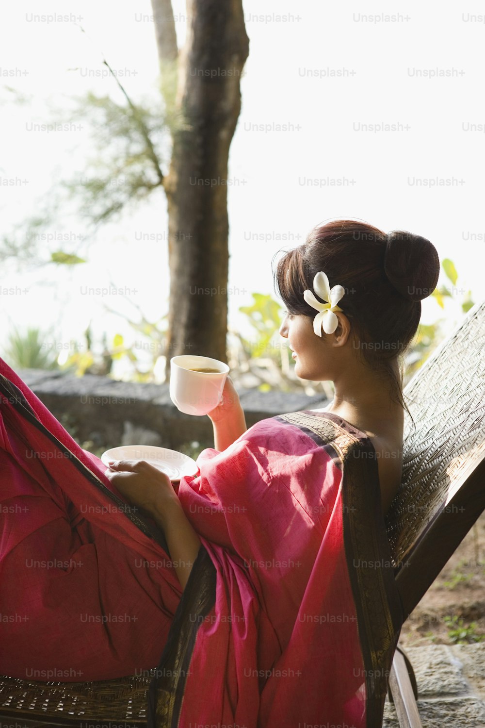 a woman in a red dress sitting on a bench