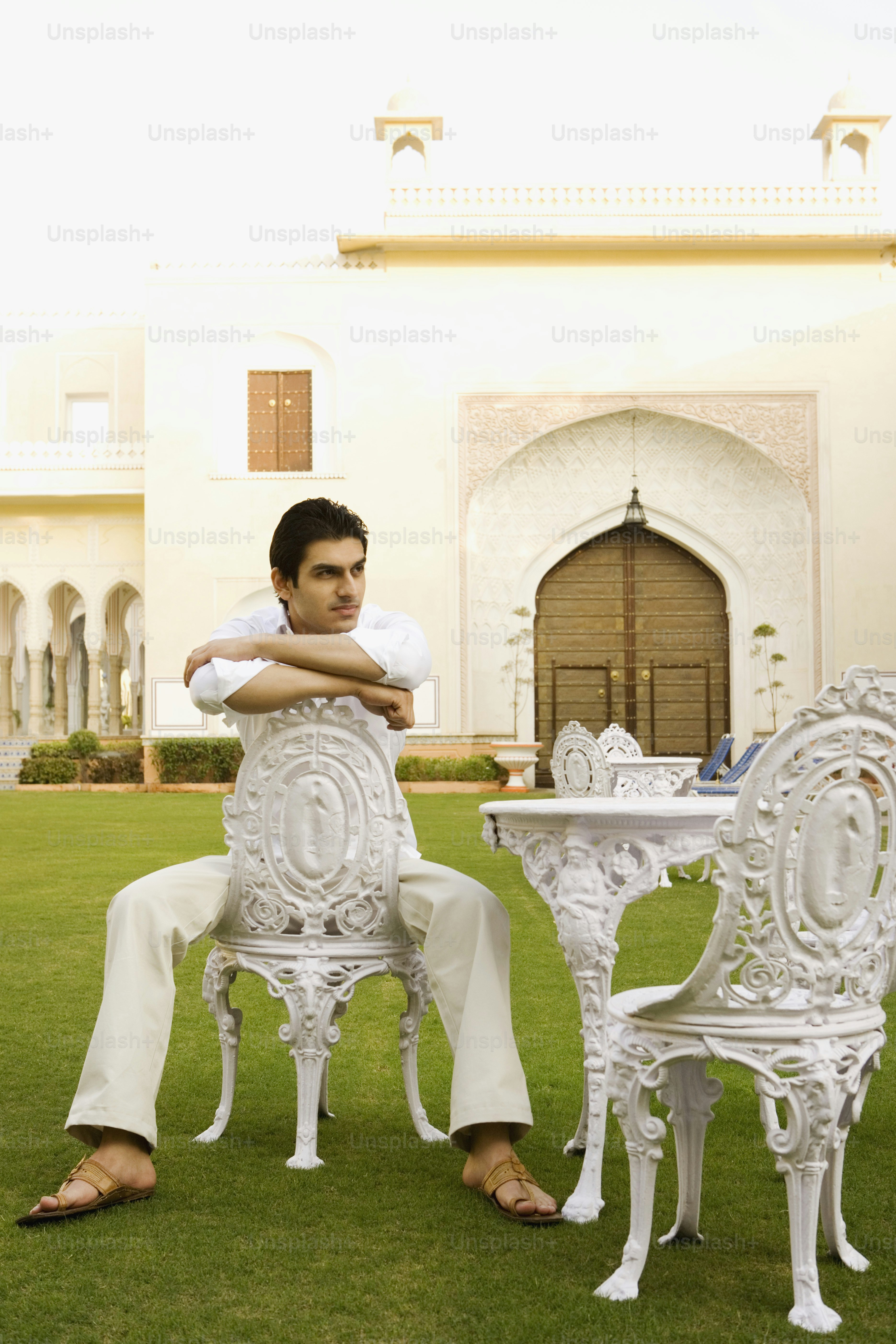 a man sitting at a table in the grass