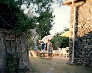 a couple of people standing under an umbrella