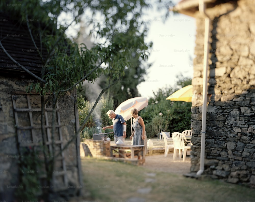 a couple of people standing under an umbrella