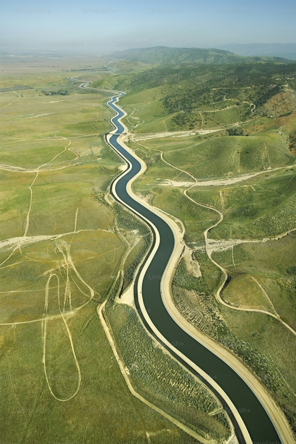 a river running through a lush green countryside