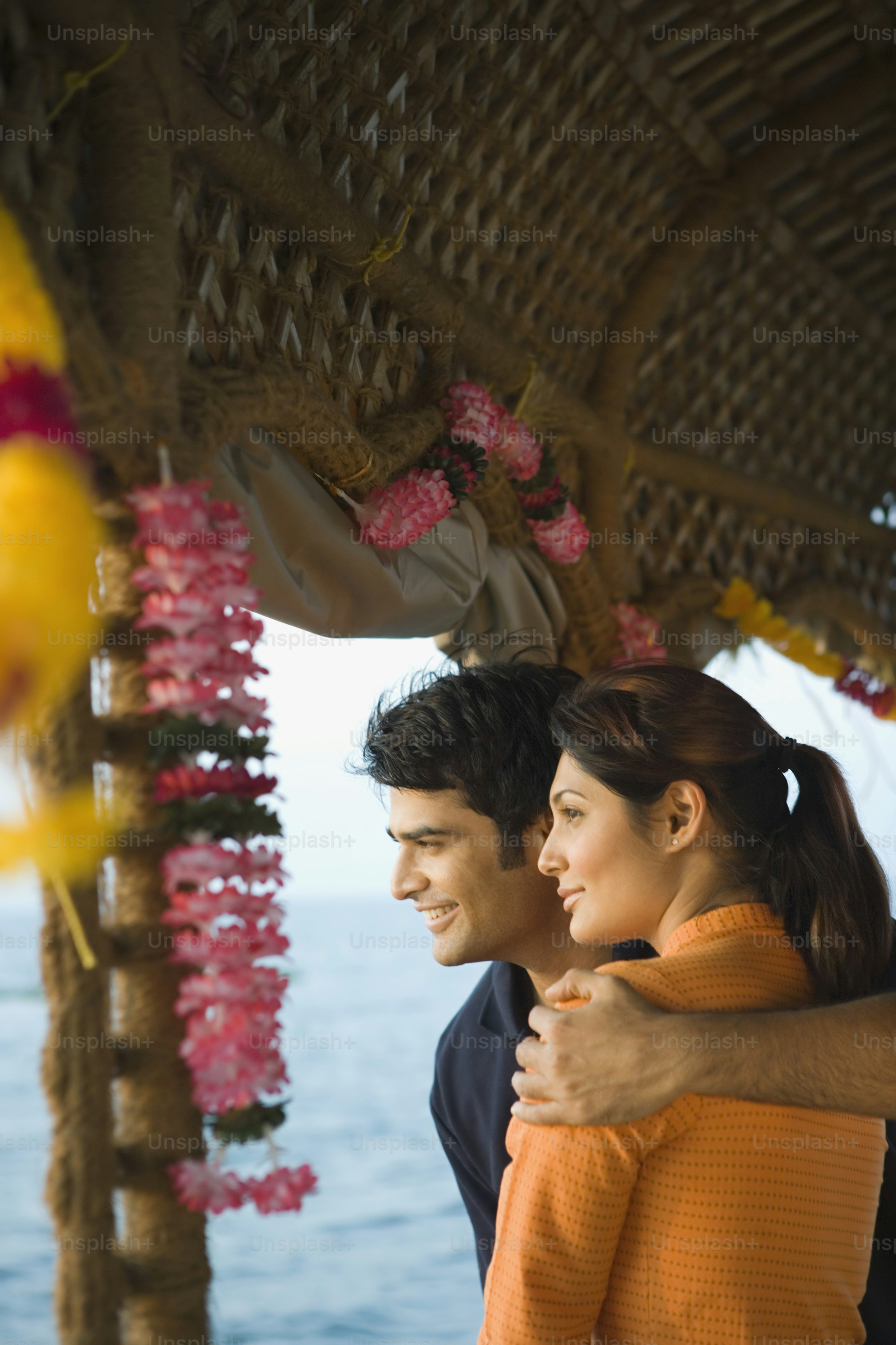 a man and a woman standing under a gazebo
