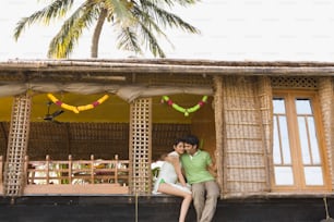 a man and a woman sitting on a porch