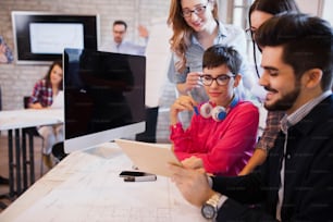 Group of young perspective designers discussing in their office