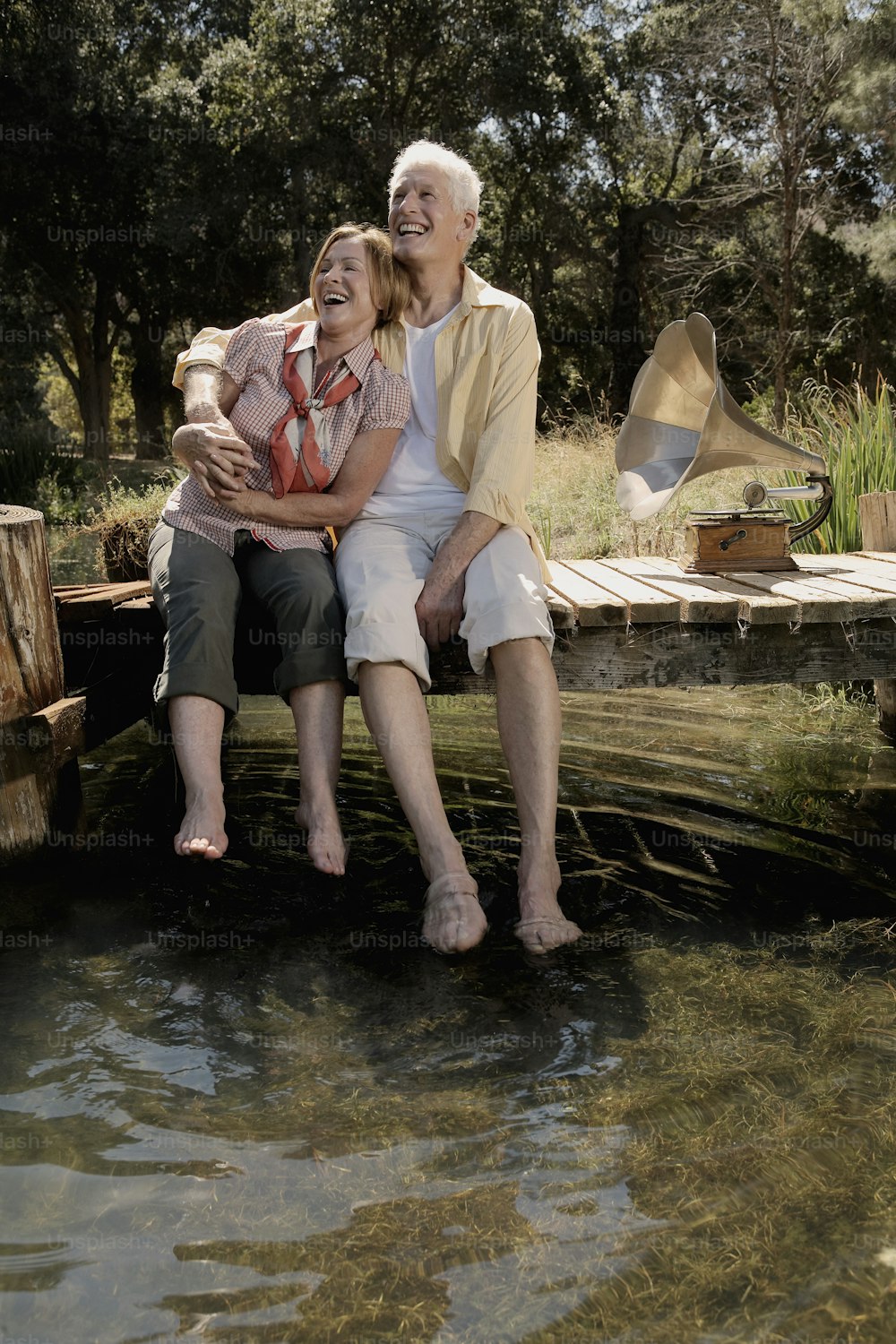 a couple of people that are sitting on a dock