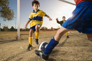 a group of young boys playing a game of soccer