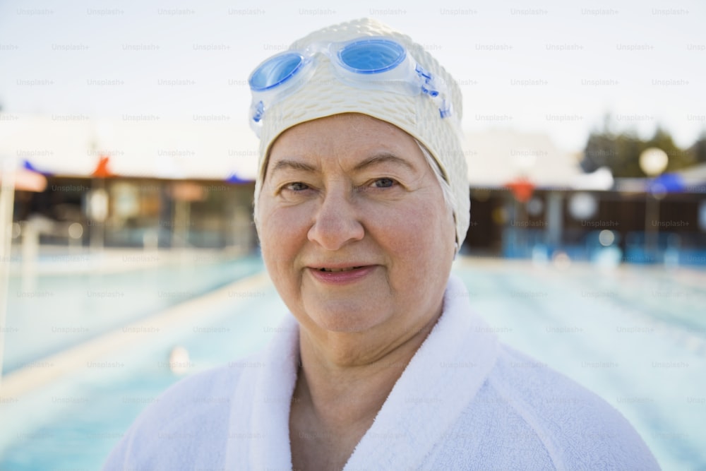 a woman wearing a white towel and blue goggles
