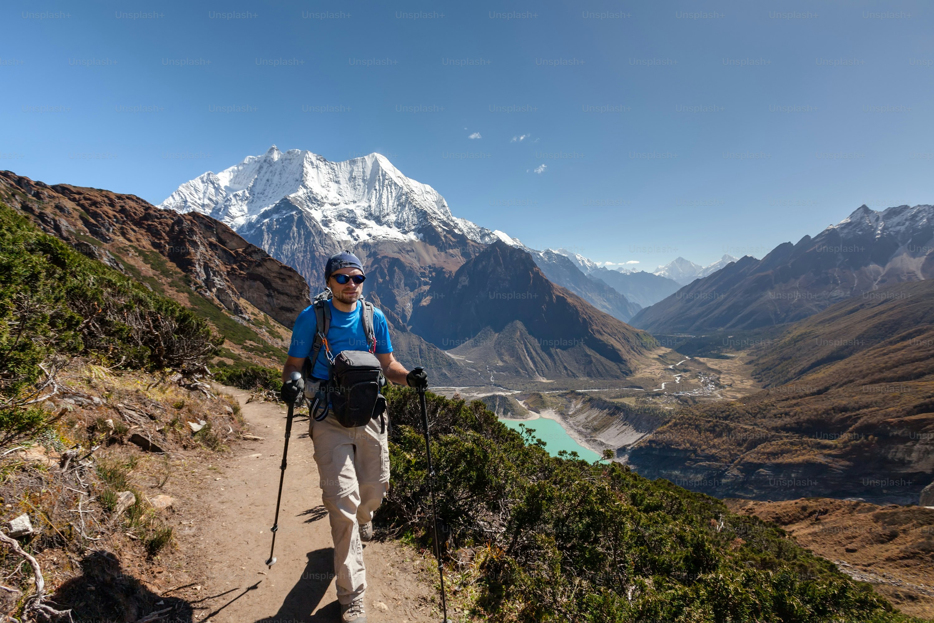 Hiker is climbig to Manaslu base camp in highlands of Himalayas on Manaslu circuit