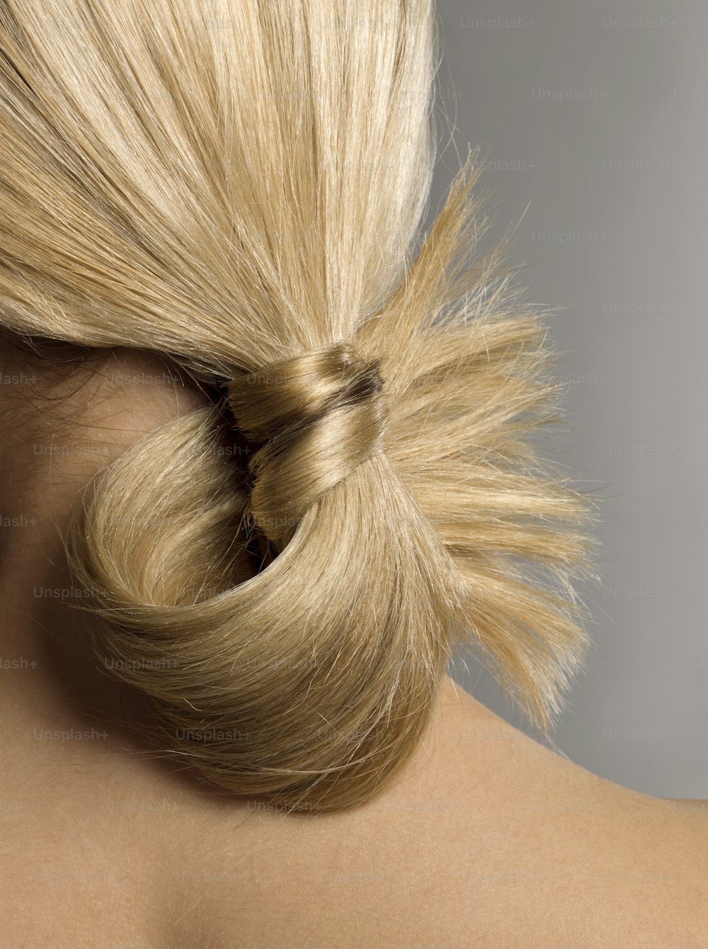 a woman with blonde hair in a ponytail