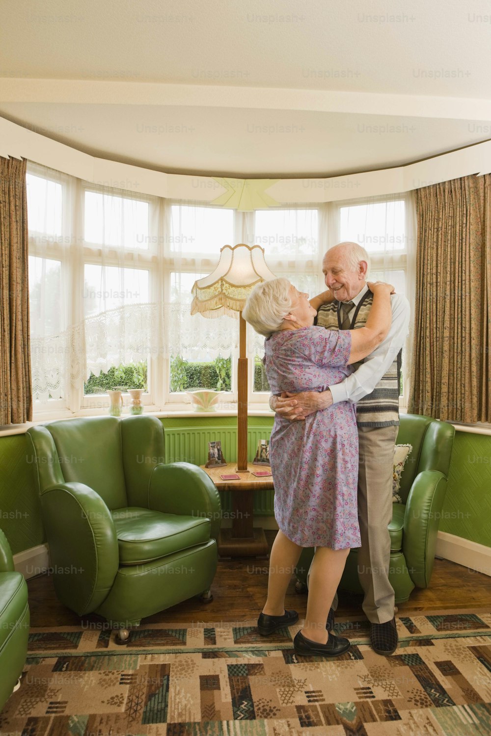 a man and a woman hugging in a living room