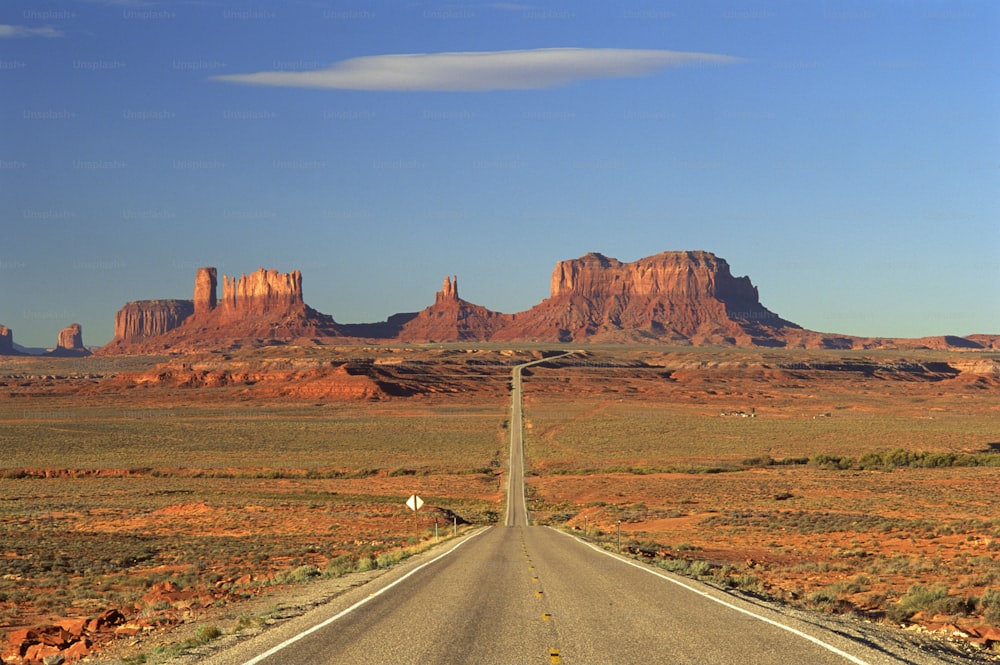 an empty road in the middle of the desert