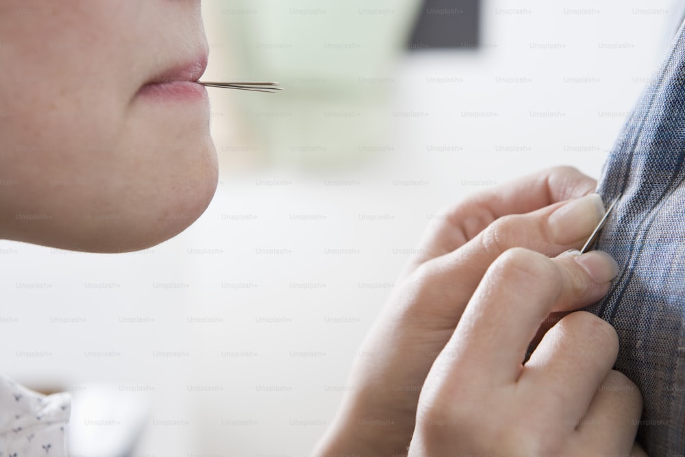 a close up of a person putting something on a jacket