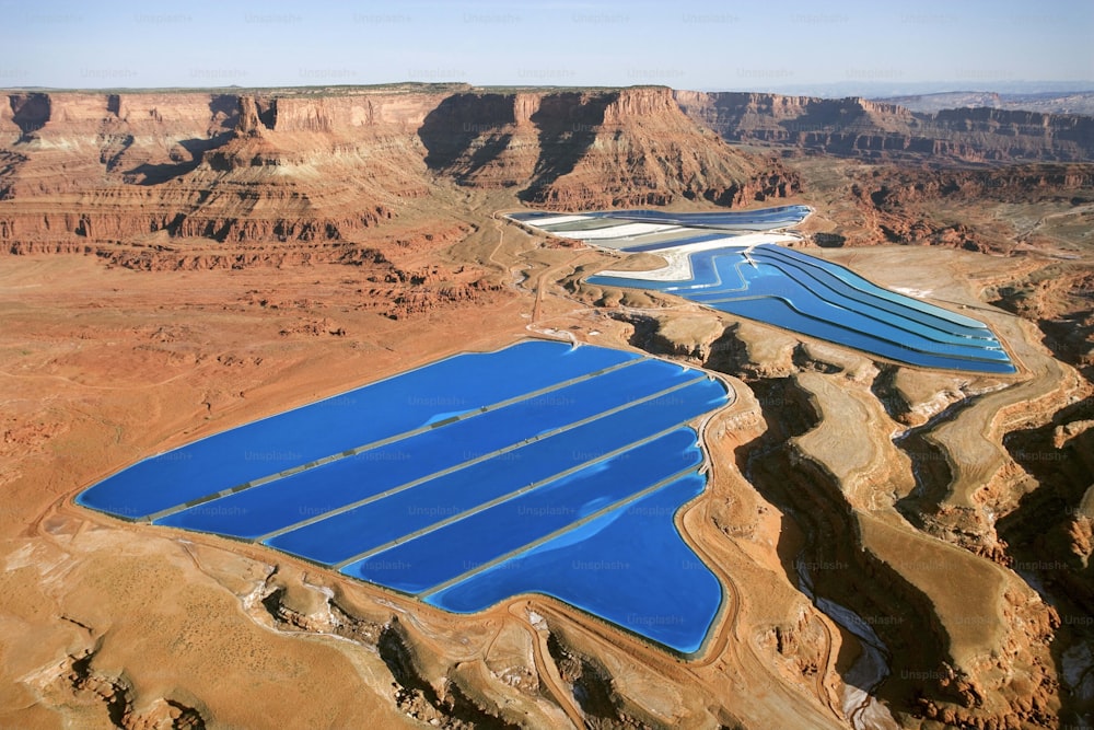 a group of large blue pools in the desert