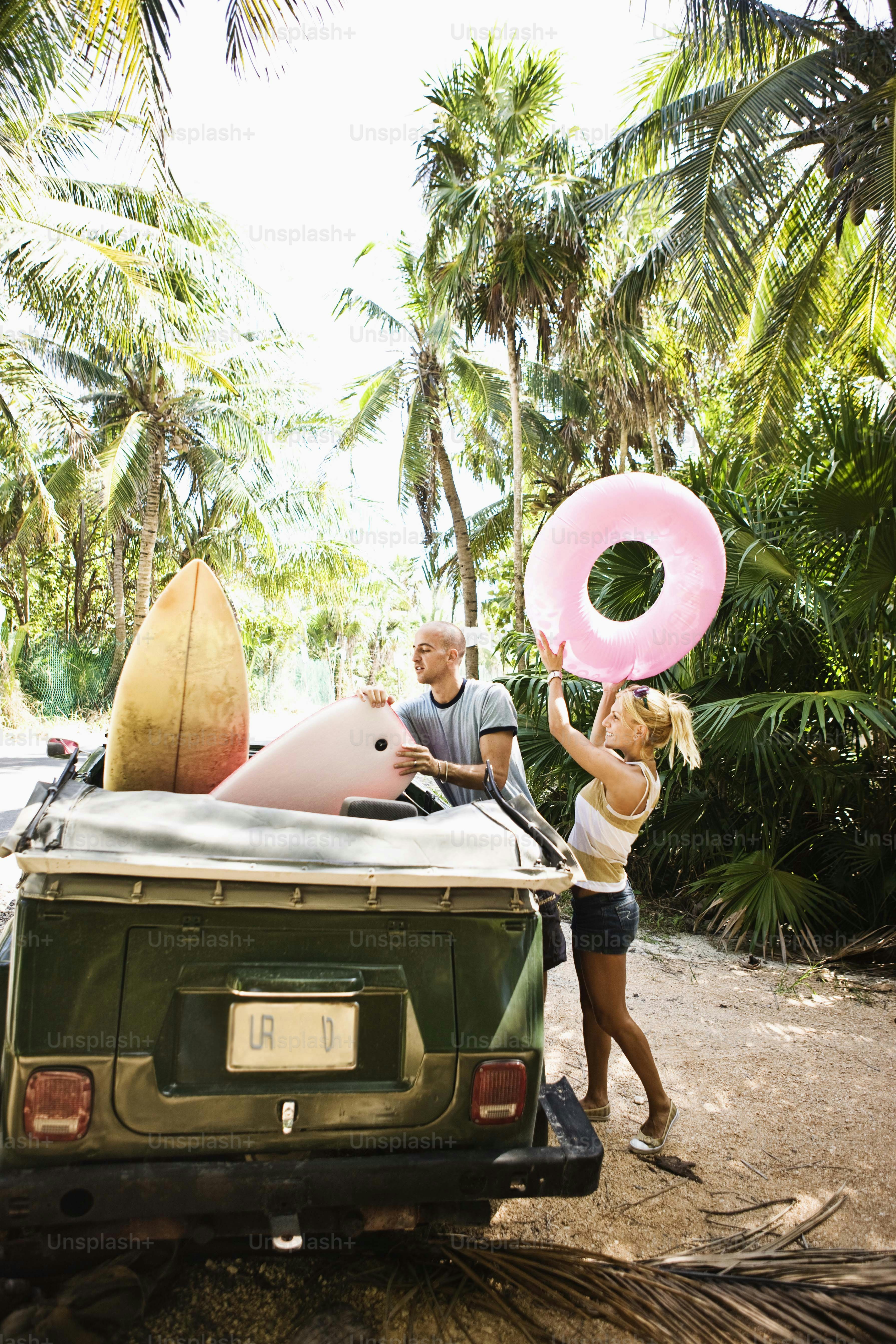 a man and a woman standing next to a jeep