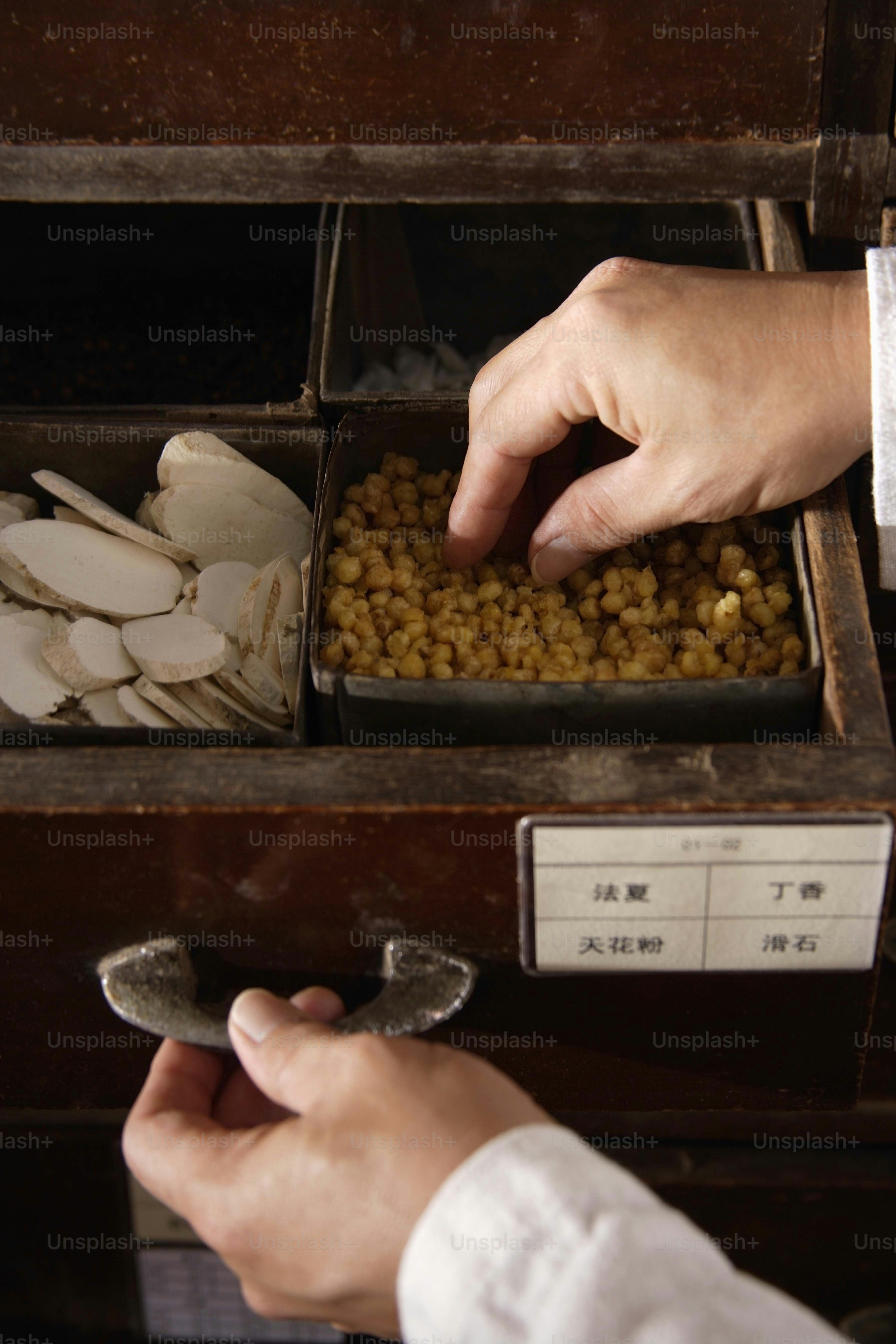 a person picking up food from a drawer