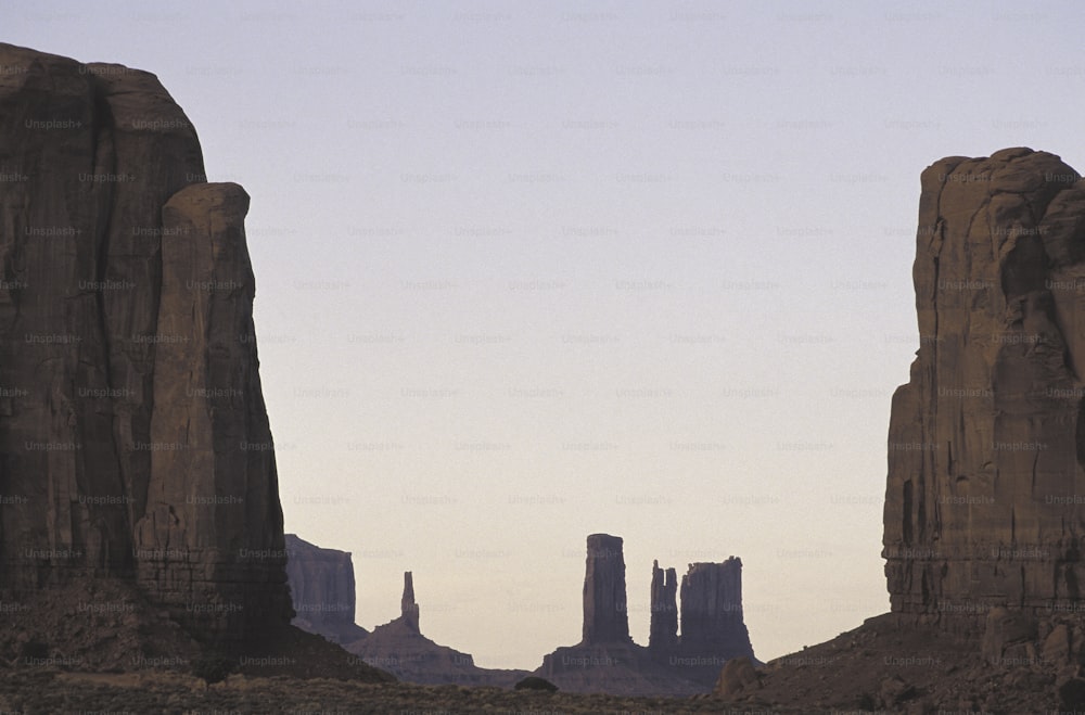 a large rock formation in the middle of a desert