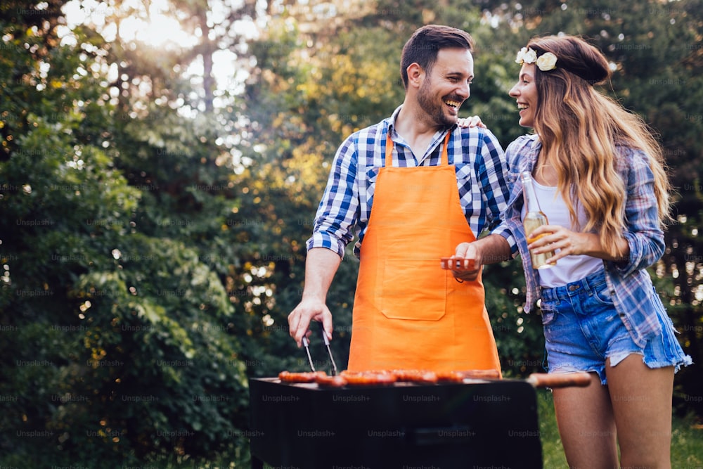 Young beautiful woman and handsome man having barbecue