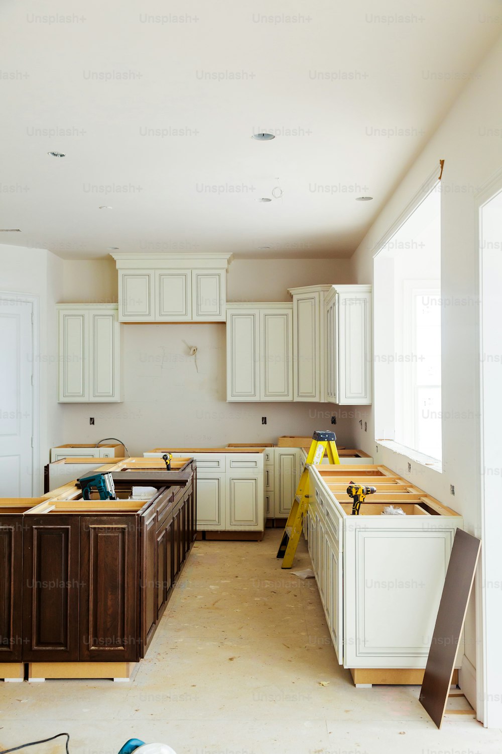 Custom kitchen cabinets in various stages of installation base for island in center