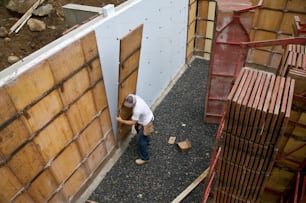 a man standing next to a wooden door