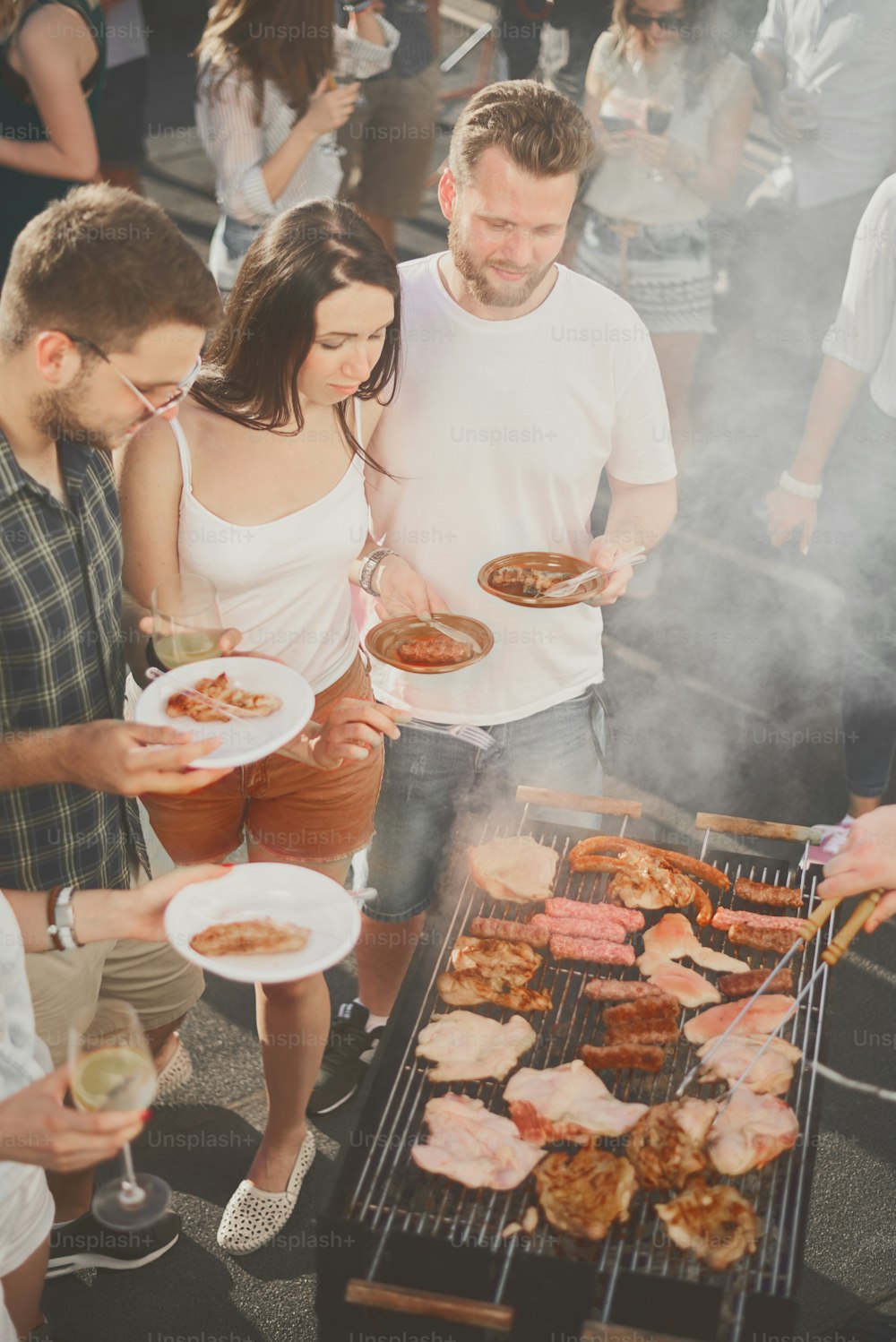 Group of people having meal at barbecue party