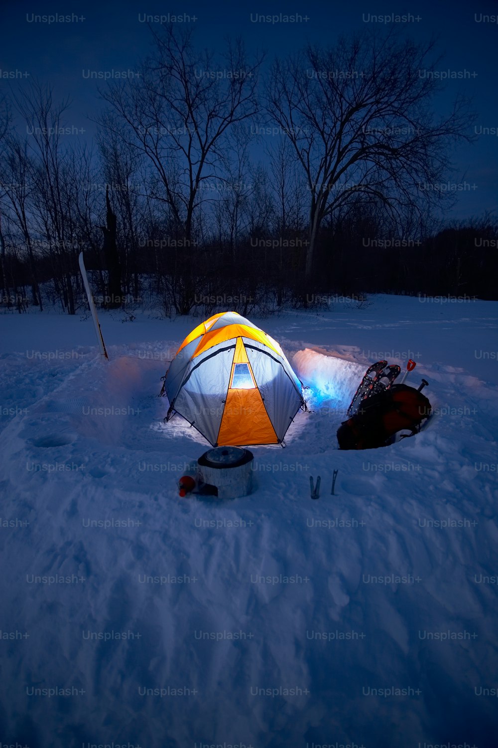 a tent sitting in the middle of a snow covered field