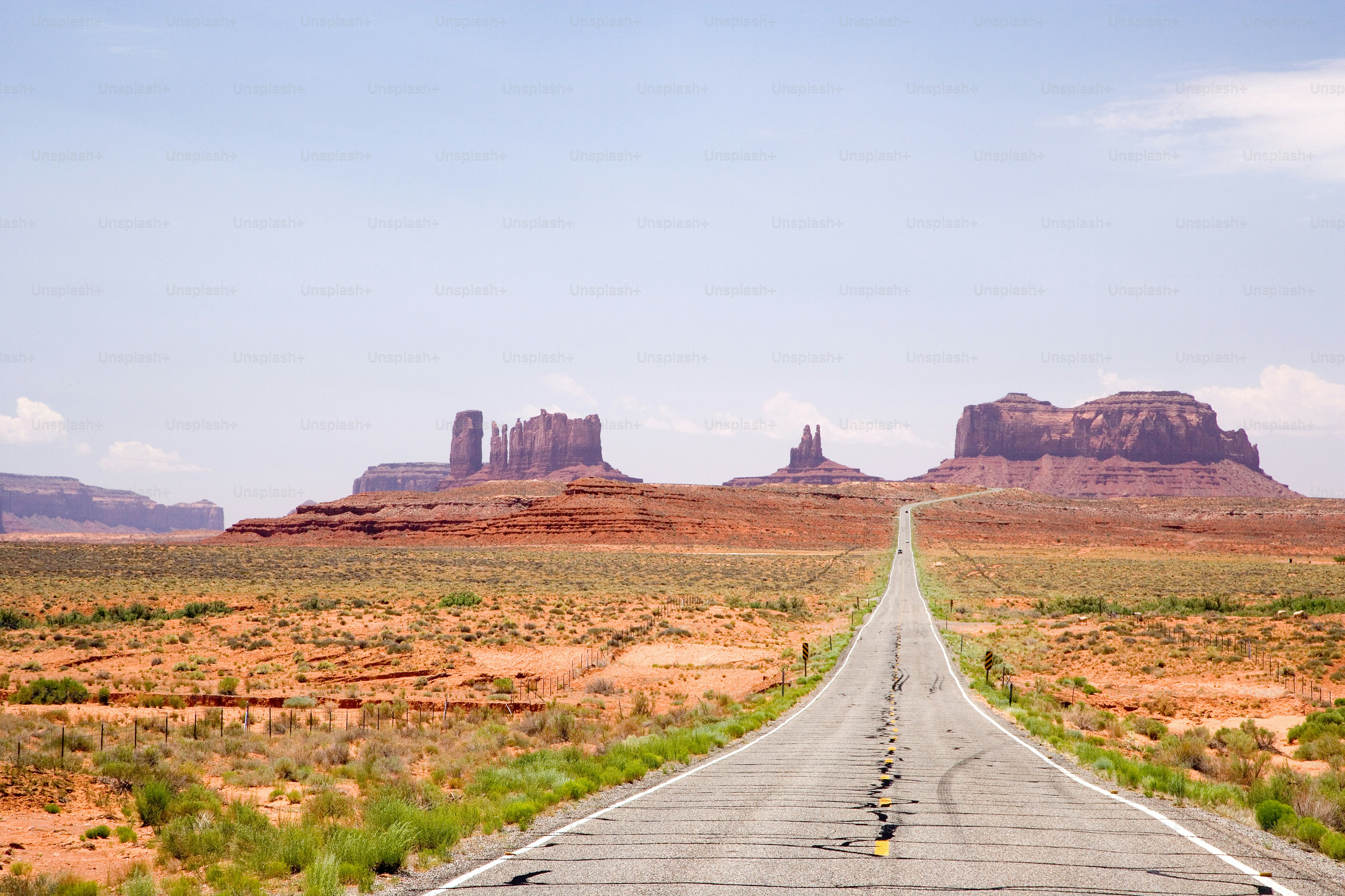 an empty road in the middle of the desert