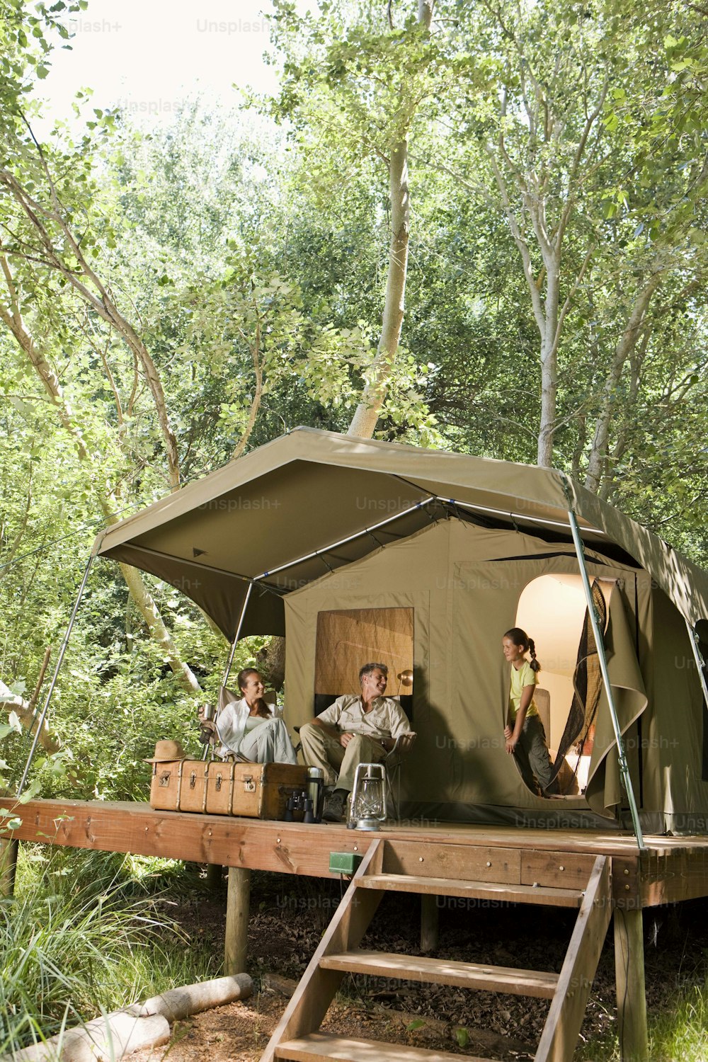 a group of people standing outside of a tent