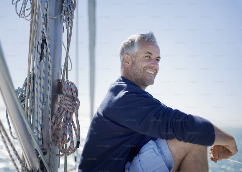 a man sitting on a boat smiling for the camera