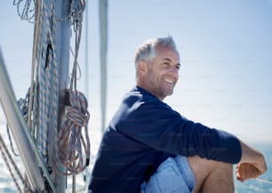 a man sitting on a boat smiling for the camera